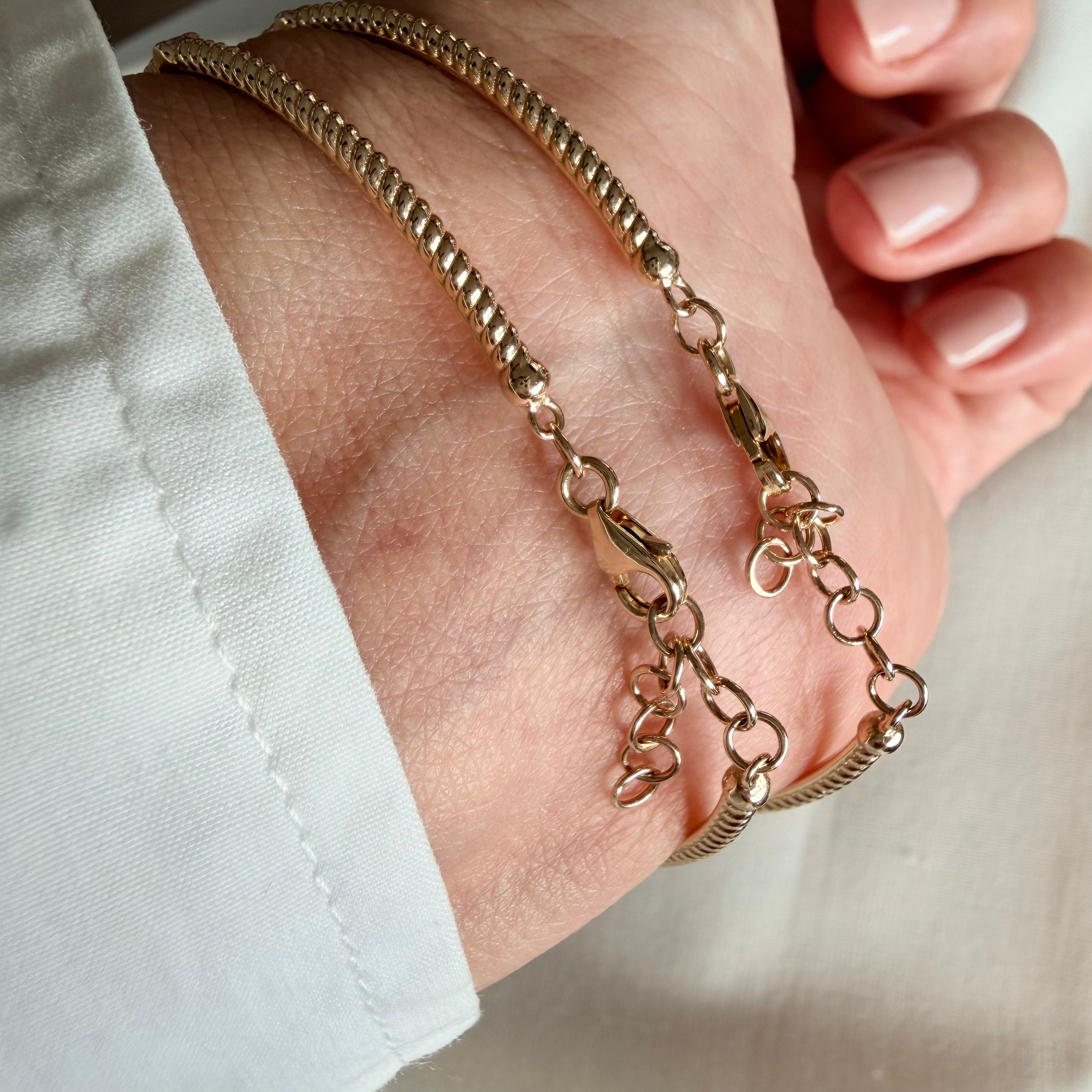 14K Gold Twisted Bracelet with Diamonds and Emerald
